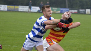 <p>Newcestown's Com Dineen being tackled by Jamie Walsh for Castlehaven. Picture: Denis Boyle</p>