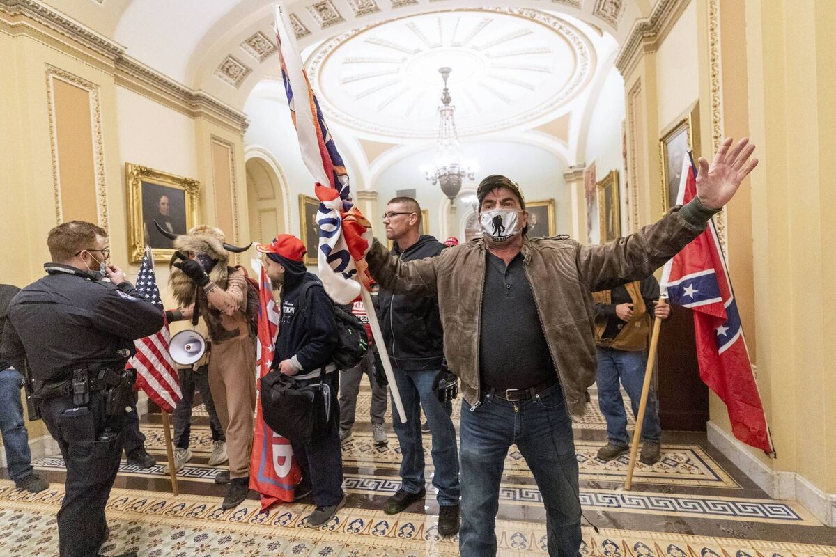 Supporters of President Donald Trump are confronted by US Capitol Police officers outside the Senate Chamber last January. Picture: AP Photo/Manuel Balce Ceneta