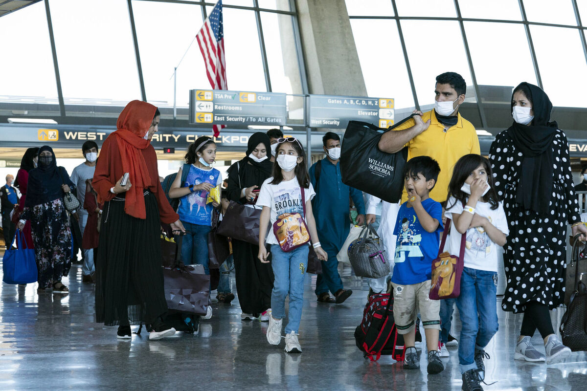 Families evacuated from Kabul, Afghanistan, walk through the terminal before boarding a bus after they arrived at Washington Dulles International Airport, in Chantilly, Va., on Thursday, Sept. 2, 2021. (AP Photo/Jose Luis Magana) Families evacuated from Kabul, Afghanistan, walk through the terminal before boarding a bus after they arrived at Washington Dulles International Airport, in Chantilly, Va., on Thursday, Sept. 2, 2021. (AP Photo/Jose Luis Magana)