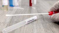 Cotton swab with tube labelled as Coronavirus