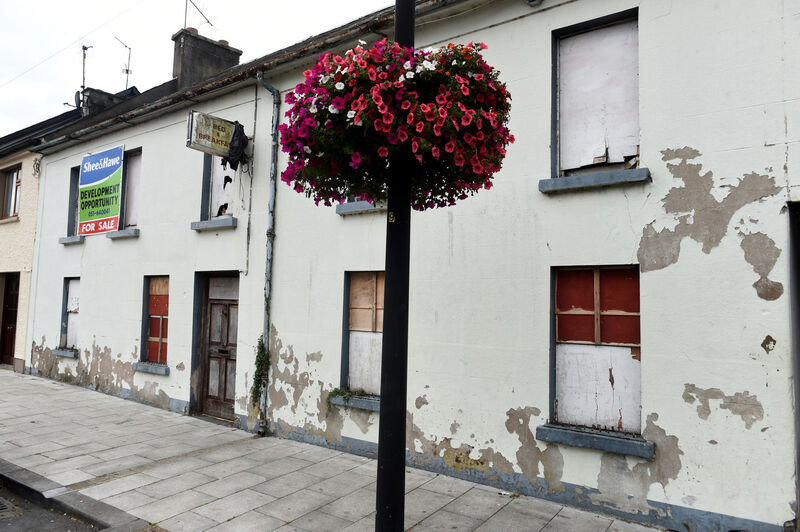 An old B&B sign hangs over a vacant premises on Kickham Street, Carrick-On-Suir, Co. Tipperary. Visually prominent derelict buildings can decrease property values and economic vitality by undermining the desirability of an area. Photo: Larry Cummins An old B&B sign hangs over a vacant premises on Kickham Street, Carrick-On-Suir, Co. Tipperary. Visually prominent derelict buildings can decrease property values and economic vitality by undermining the desirability of an area. Photo: Larry Cummins