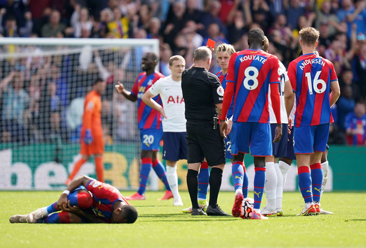 Referee Jon Moss sends off Tottenham Hotspur's Japhet Tanganga.
