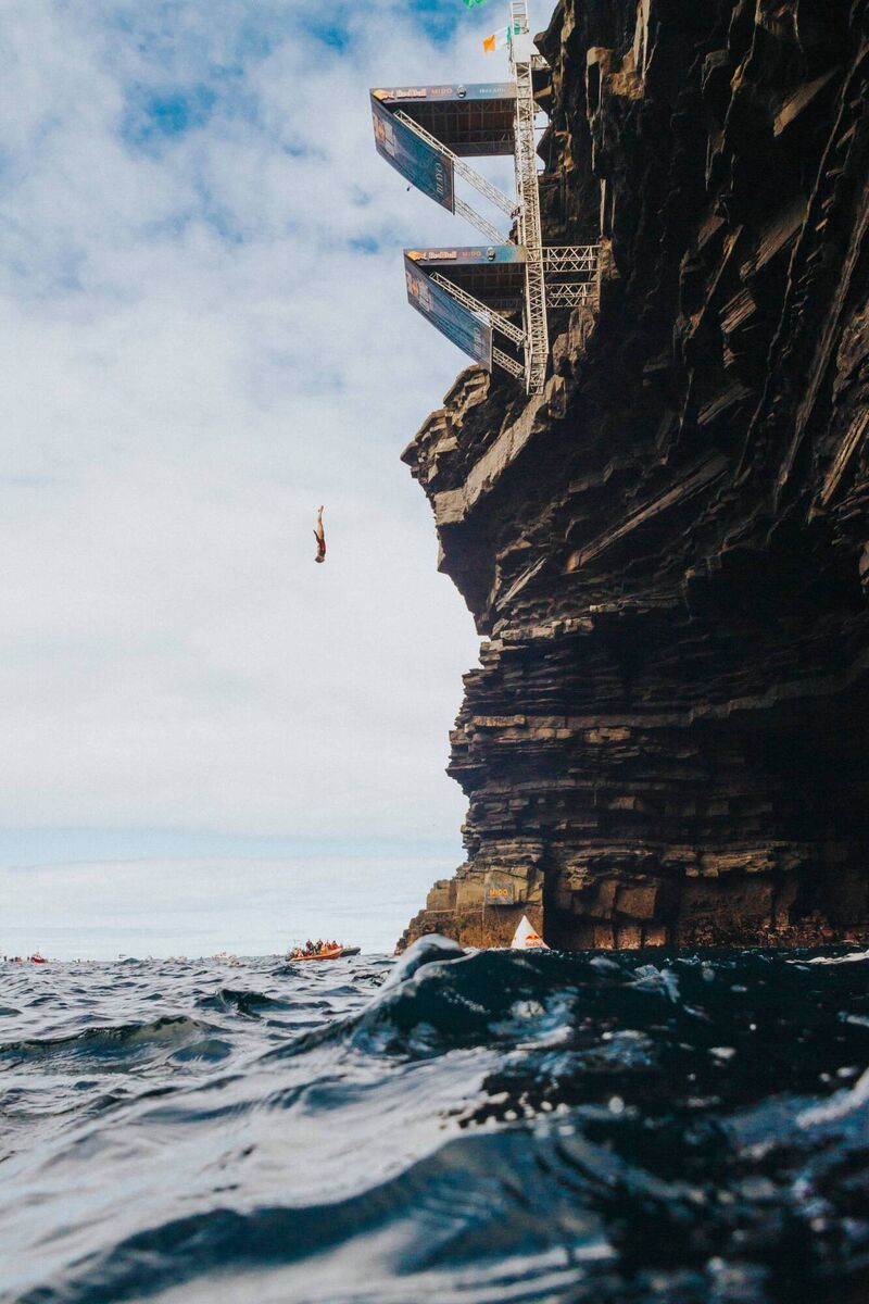 Constantin Popovici of Romania dives from the 27.5 metre platform during the final competition day of the fourth stop of the Red Bull Cliff Diving World Series at Downpatrick Head, Ireland on September 12, 2021. Constantin Popovici of Romania dives from the 27.5 metre platform during the final competition day of the fourth stop of the Red Bull Cliff Diving World Series at Downpatrick Head, Ireland on September 12, 2021.