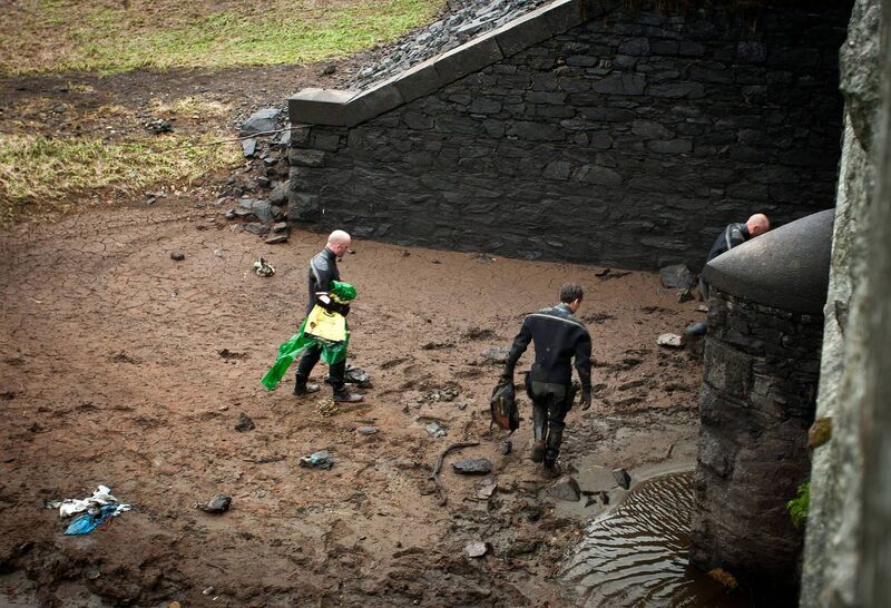 Members of the Garda water unit recover items including a rucksack from the reservoir near Roundwood, Co Wicklow. Picture Garry O'Neill