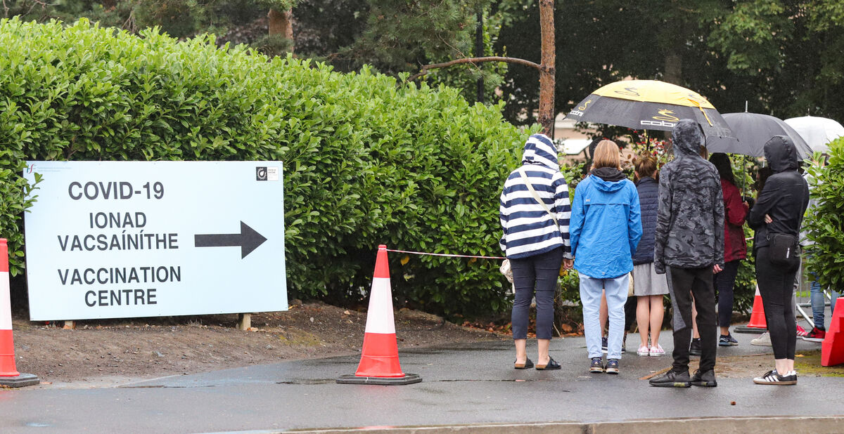 Parents and children queue in the rain outside the Citywest Covid-19 Vaccination Centre in Dublin. File Picture: PA
