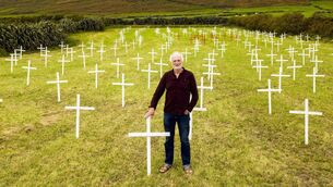 <p> Breanndán Ó Beaglaoich with his installation of crosses. Picture: Mossy Donegan </p>