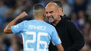 <p>Manchester City's Riyad Mahrez speaks with manager Pep Guardiola on the touchline at the Etihad Stadium. Picture: Martin Rickett/PA</p>