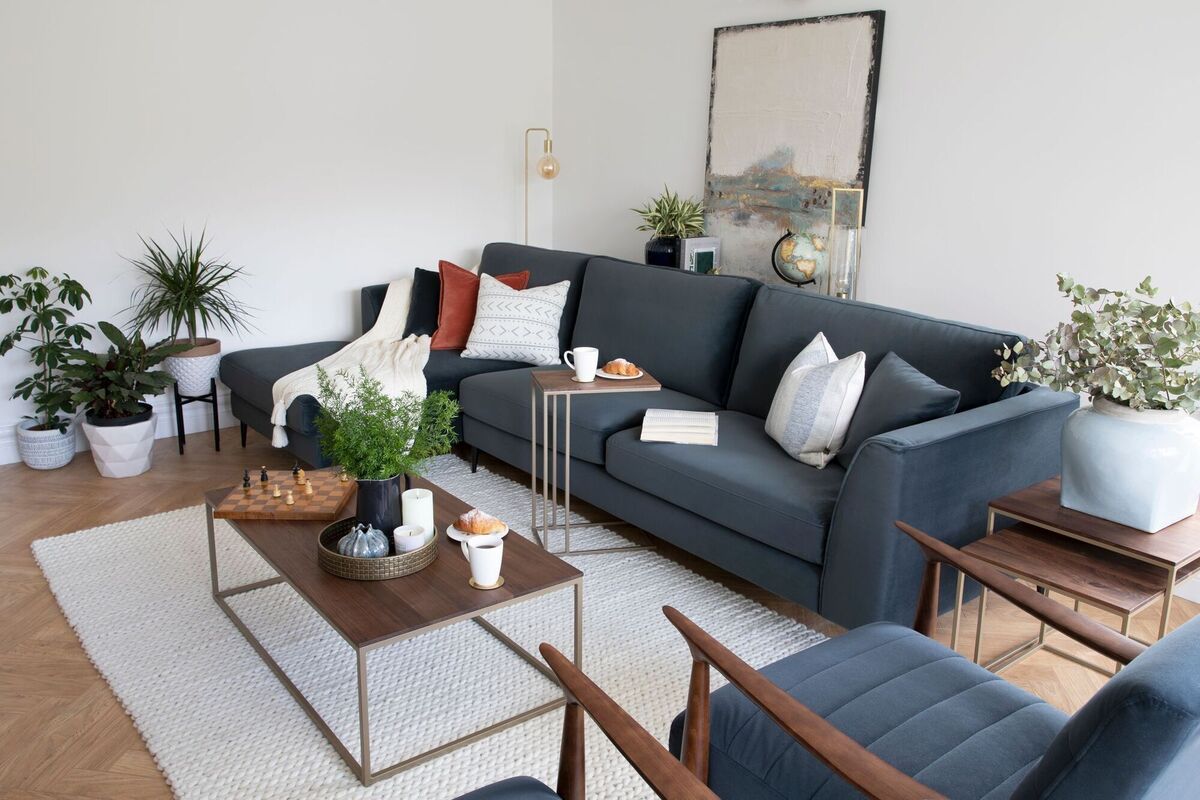  The Ashton rectangular coffee table featuring wood on a metal frame work (€449) is styled with candles, ceramics and greenery, pulled together on the Stavo bronze tray (€29). From EZ Living Interiors.