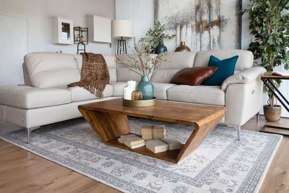  Curved edges on the Eden coffee table mean no sharp corners when navigating round it to the corner sofa. Its surface space is augmented by a floor level shelf (€329). From EZ Living Interiors.