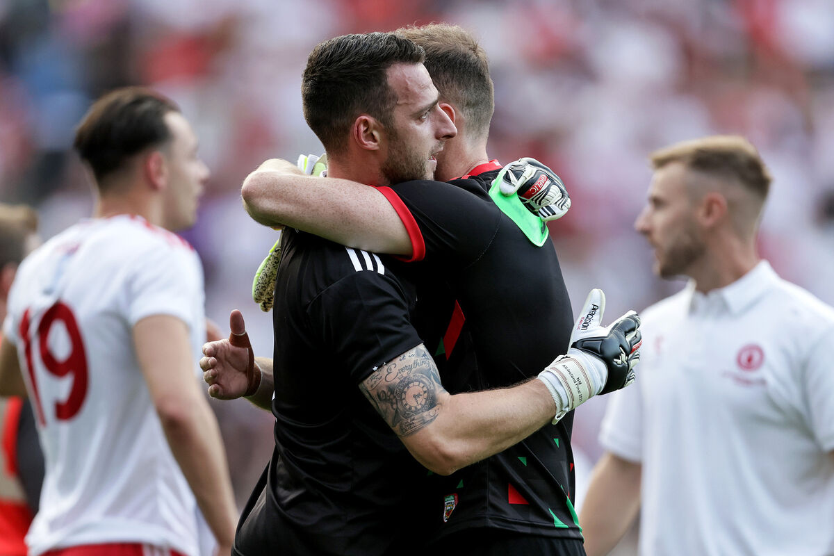Tyrone goalkeeper Niall Morgan consoles a dejected Mayo goalkeeper Rob Hennelly. Picture: INPHO/Laszlo Geczo