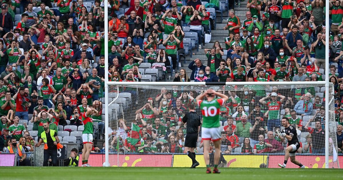 Tyrone goalkeeper Niall Morgan celebrates as Ryan O'Donoghue of Mayo and Mayo supporters behind the goal react to a missed penalty. Picture: Brendan Moran/Sportsfile