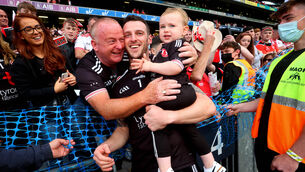 <p>Tyrone goalkeeper Niall Morgan celebrates with his son Criostai after the All-Ireland final win over Mayo. Picture: INPHO/Ryan Byrne</p>