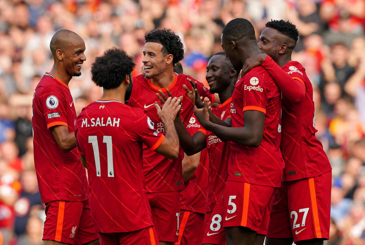 Liverpool's Naby Keita (8) celebrates with team-mates after scoring their side's third goal of the game