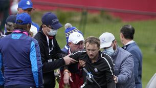 Actor Tom Felton is helped after collapsing on the 18th hole during a practice day at the Ryder Cup at the Whistling Straits Golf Course (Ashley Landis/AP)
