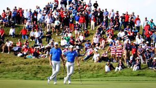 <p>Ian Poulter and Rory McIlroy look on from the 11th green during Friday Morning Foursome Matches. Picture: Warren Little/Getty Images</p>