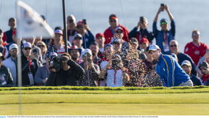 <p>Rory McIlroy of Team Europe chips onto the green during their Friday morning fourball match. Picture: Tom Russo/Sportsfile</p>