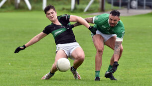 <p>Nemo Rangers' Mark Hill and St. Vincent's Mike O'Leary tussle for the ball during the Bon Secours Cork PIFC at Rathpeacon. Picture: Eddie O'Hare</p>