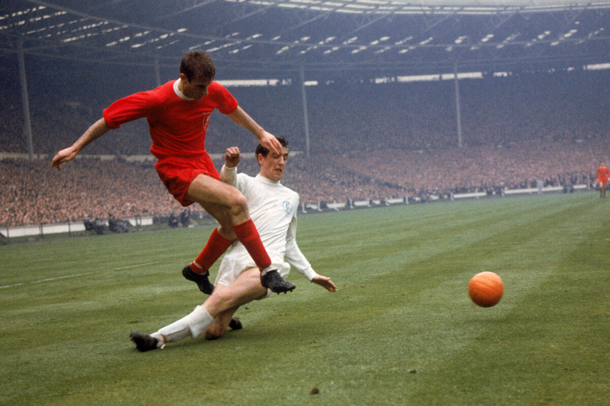 Leeds United's Norman Hunter (r) slides in too late to prevent Liverpool's Roger Hunt (l) firing the ball across Leeds United's Norman Hunter (r) slides in too late to prevent Liverpool's Roger Hunt (l) firing the ball across