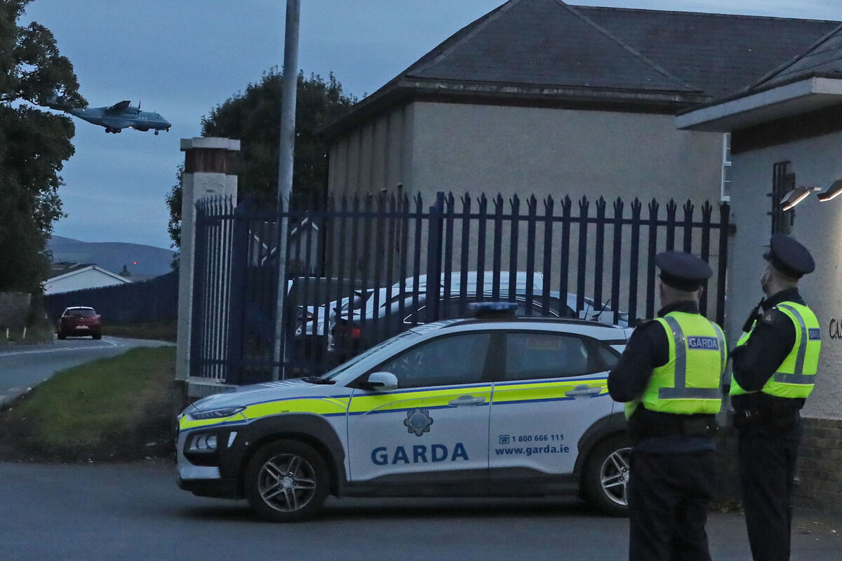 Members of An Garda Síochána outside Casement Aerodrome, Baldonnel, the Irish Air Corps base, as a plane carrying Gerry Hutch lands. Picture: Brian Lawless/PA Wire