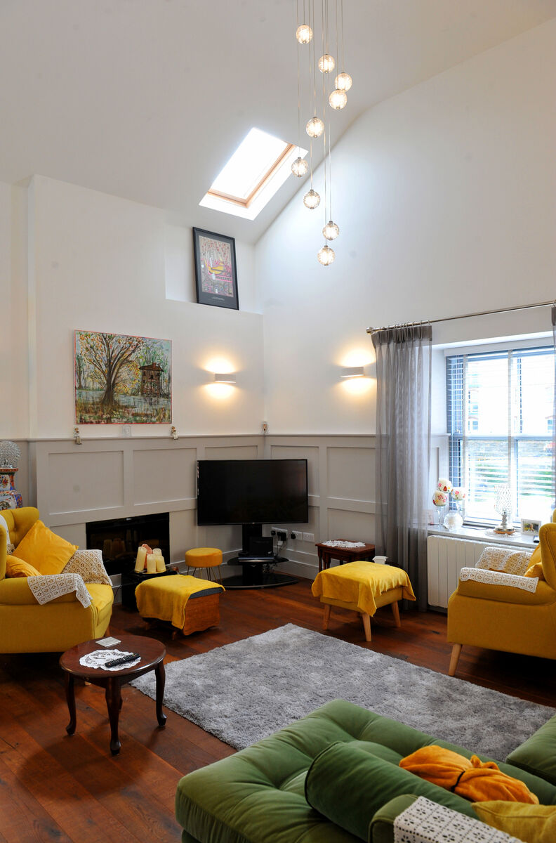 Interior designer Stephanie Hennessy was determined to use panelling in the cottage to introduce warmth and character. The palette is suspended on white walls, grey panelling and toffee dark timber flooring. The lush citrus shaded velvet furnishings give Rena that colour she craves.
