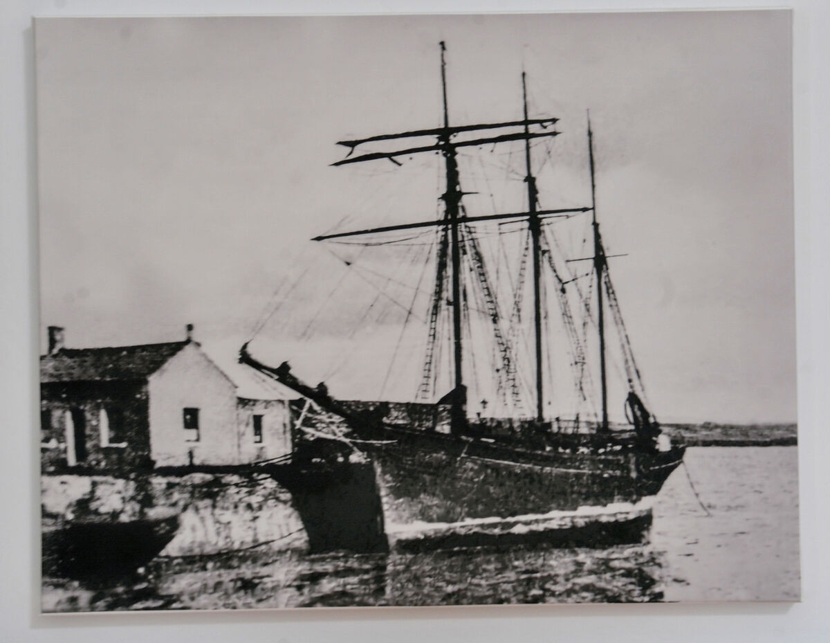  An old black and white photo image of the schooner 'Kathleen &amp; May' berthed beside the cottage in 1924. Between 1908 and 1931 the schooner was based in Youghal as a part of the Martin J Fleming coal shipping fleet.