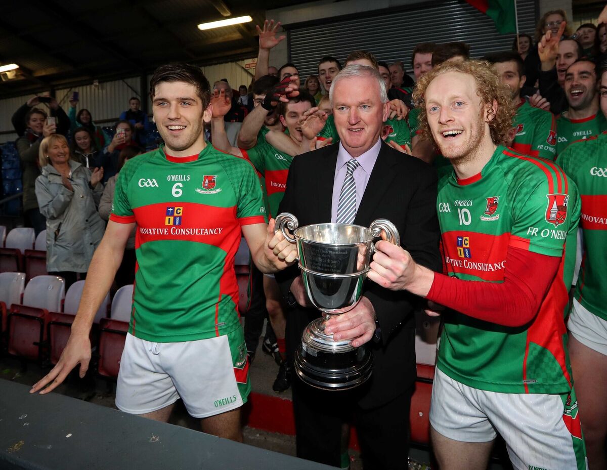 Ger Lane, Chairman Cork County Board, presents Joint Fr. O'Neills Captains, Adrian Kenneally and Podge Butler, with the Cup after their win against Kildorrery in 2016. Picture: Jim Coughlan.