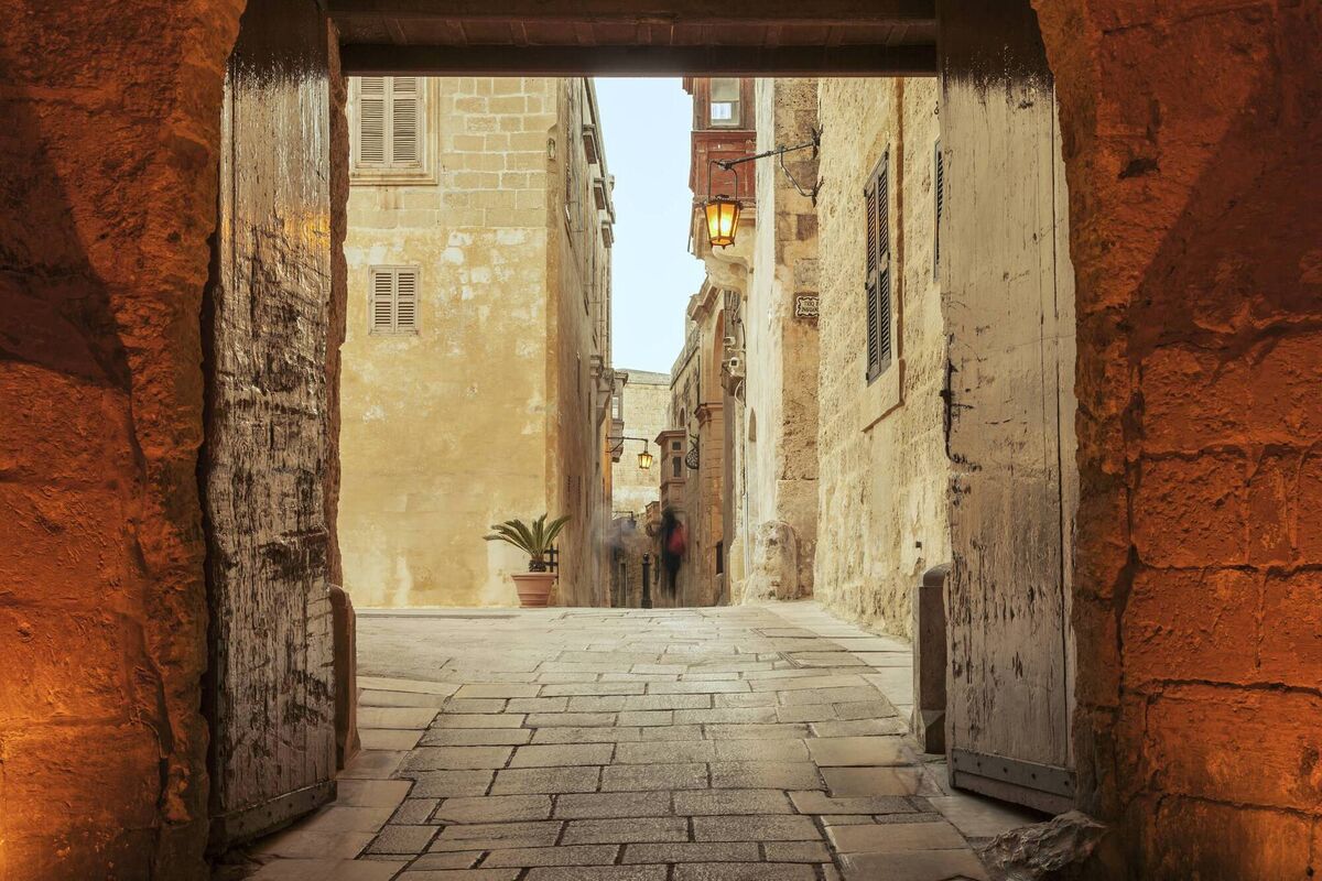 Narrow medieval street at dusk, Mdina Old City, Malta 