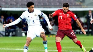<p>RED RAGE: Northern Ireland's Jamal Lewis battles for possession before his controversial sending off in Geneva.</p>