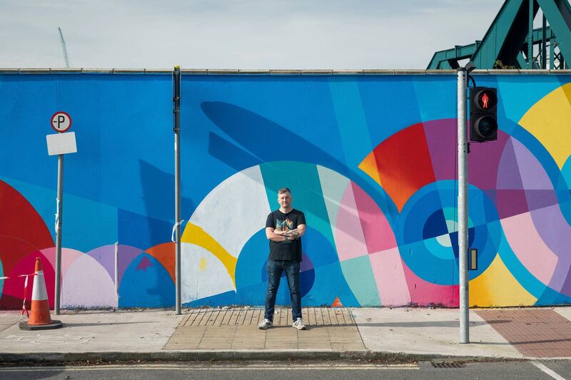Artist Shane O'Malley at his new mural on the Lower Glanmire Rd, Cork, for Ardú 2021. Picture: Jed Niezgoda