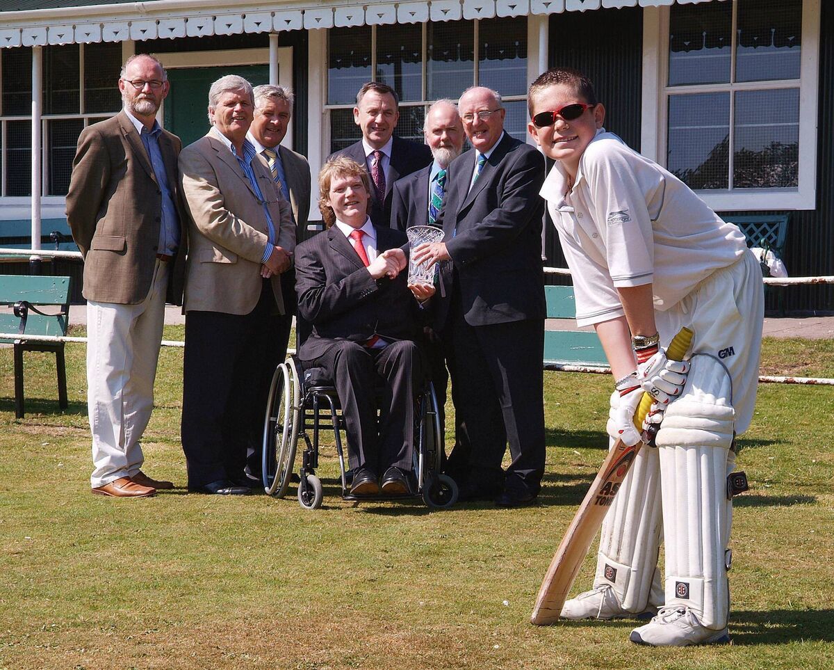 Dermot Giltinan of the Cork County Cricket Club received a Cork Person of the Month award to mark his contribution to cricket over the decades. L-R: Frank Dowling, Southern Adv. (Sponsors); Manus O'Callaghan, Awards Organiser; Dr. Dick Creedon, Cricket Club Committee; Padraig Mallon, Cricket Club Committee; Kieran Aherne, Cricket Club President; and Dermot Giltinan receiving his Cork Person of the Month award from Brian Crowley MEP. Foreground: Oliver Creedon, youth team member Cork County Cricket Club.