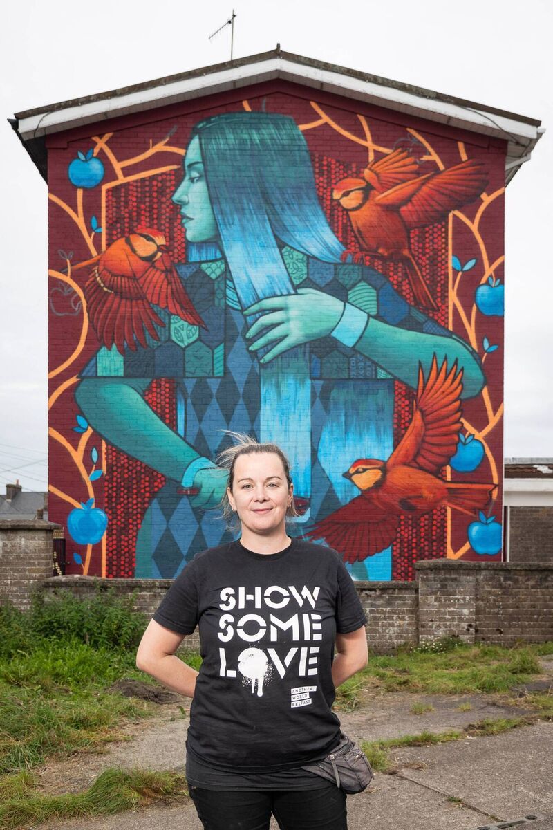 Sligo-born artist Friz pictured at her mural at St. Finbarr’s Road, Cork, as part of Ardú Street Project 2021. Friz’s mural is a depiction of the Goddess Clíodhna, her style was inspired by the Honan Chapel’s mosaics and Harry Clarke stained glass. Pic: Jed Niezgoda