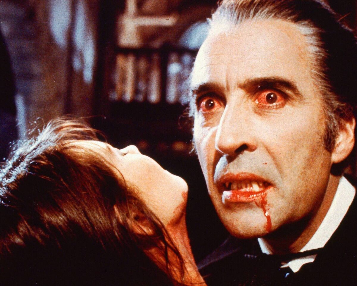  Christopher Lee as  Dracula.