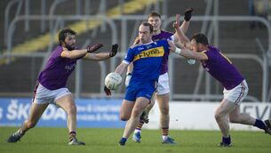 <p>Alan Callaghan and Stephen Sheppard trying to block down Eamon Wallace's shot for Ratoath against Wolfe Tones in the Meath SFC Semi-Final. Photo: John Quirke </p>
