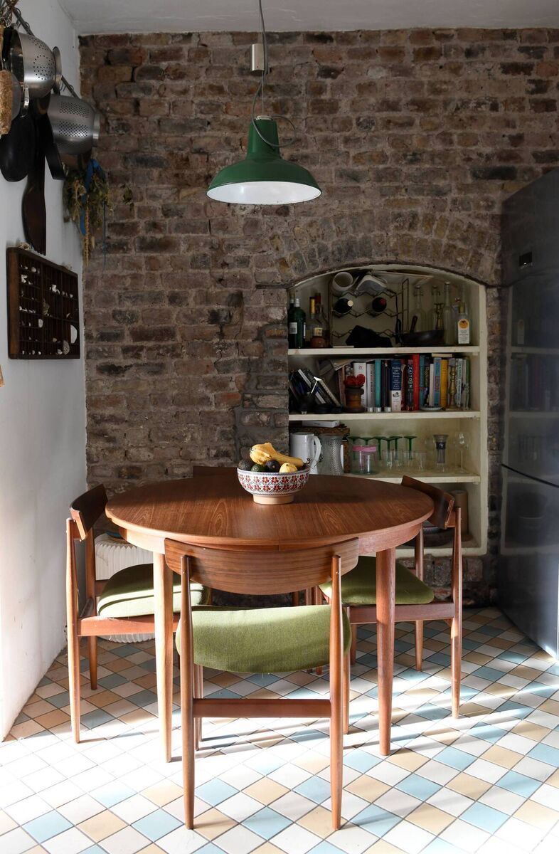 Exposed brickwork and niche shelving in the kitchen