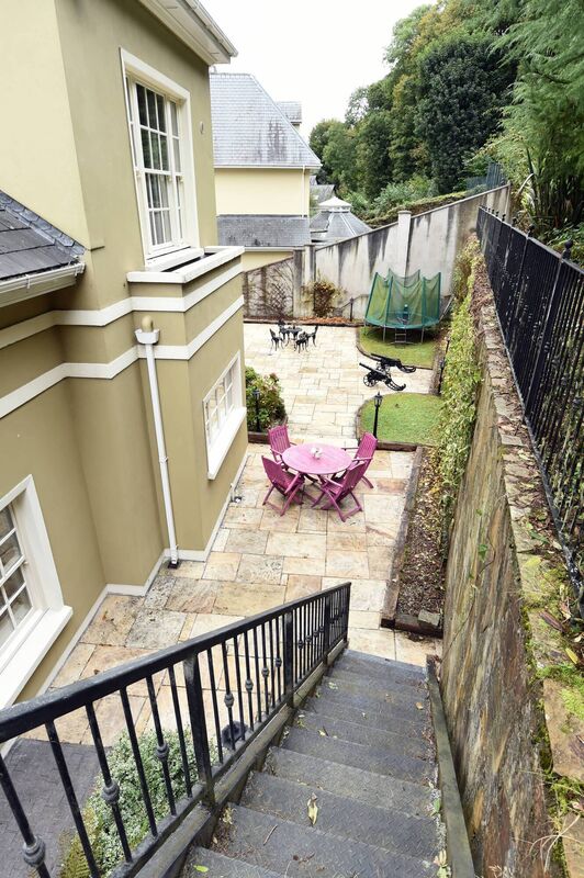 Tiered rear garden faces south and steps up into steep woodland below Maryborough Hill and Elden