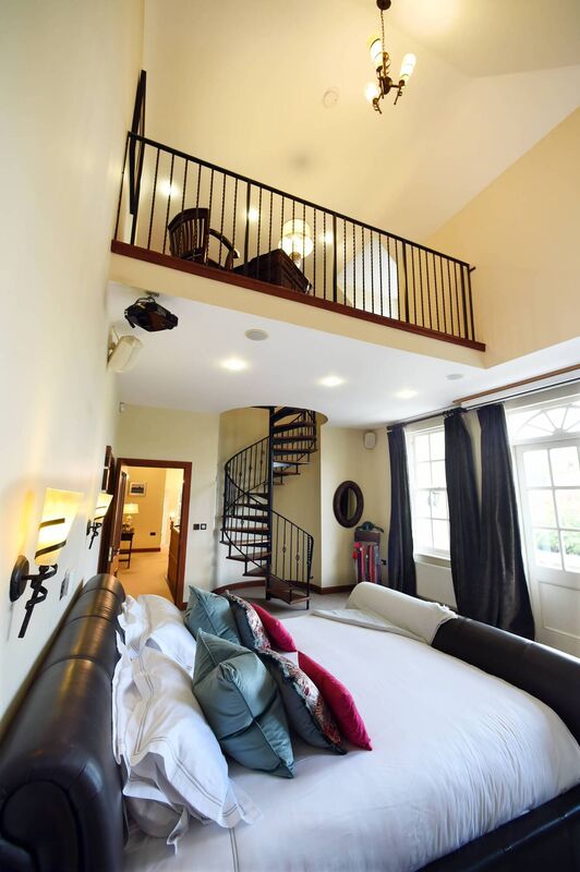 Upwardly mobile: main bedroom suite has a mezzanine reached via spiral stairs, with the 850 sq ft gym behind it