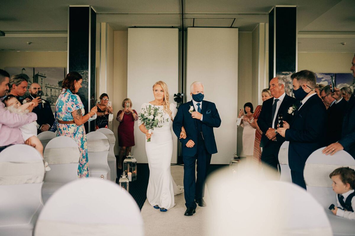 Jenny Corcoran walks up the aisle with her dad Jim. Jenny Corcoran walks up the aisle with her dad Jim.