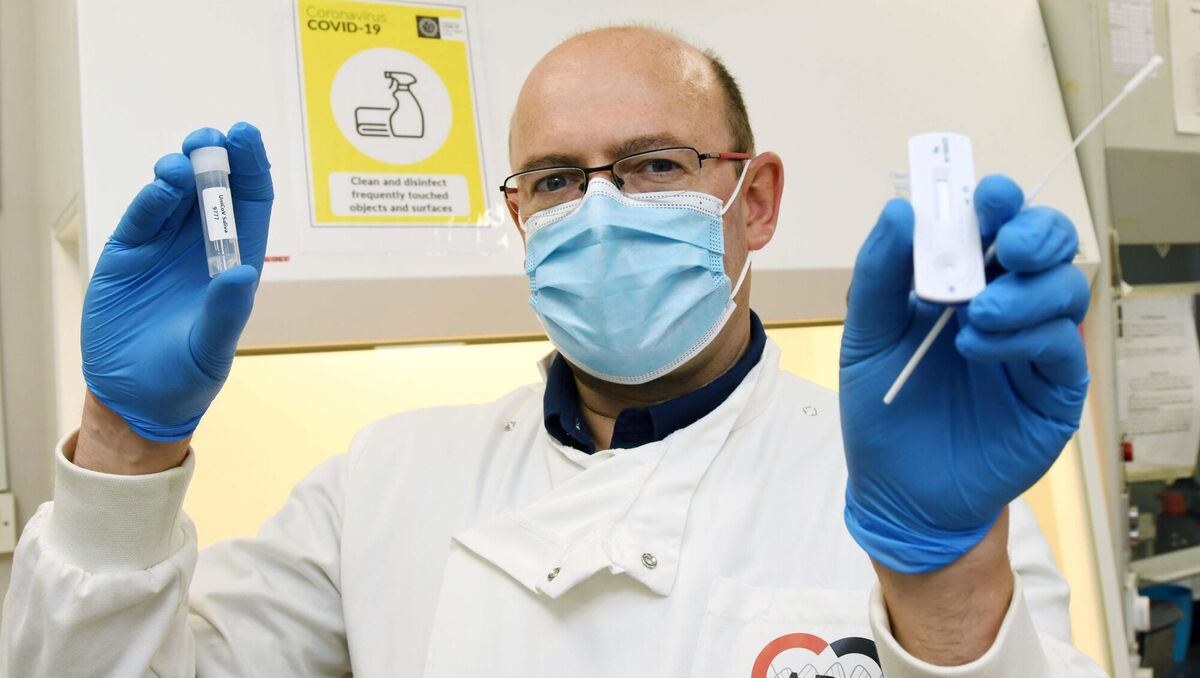 John Mac Sharry holding an antigen test and a saliva collection tube in the UniCov UCC Lab team in Cork. Picture: Denis Minihane.