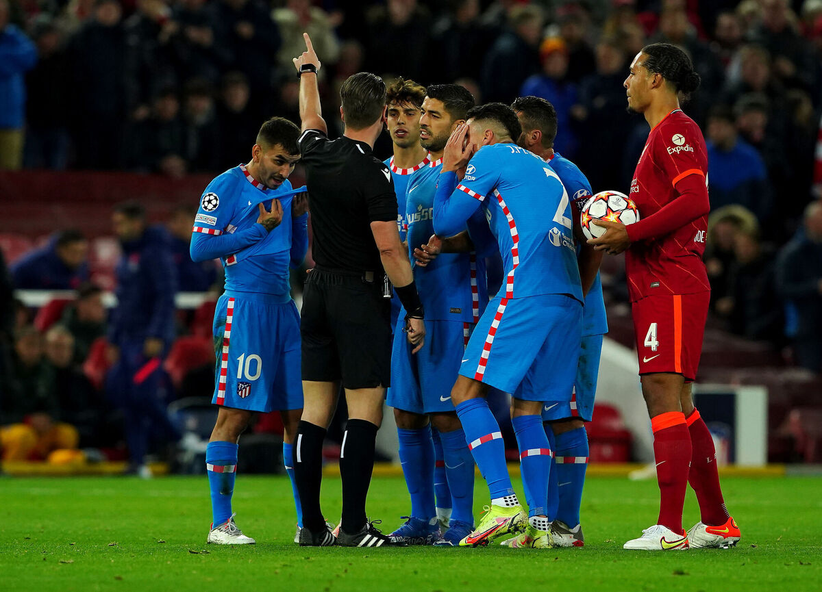 Atletico Madrid players protest to referee Danny Makkelie after showing Atletico Madrid's Augusto Felipe (not pictured) a red card. Picture: Peter Byrne/PA 