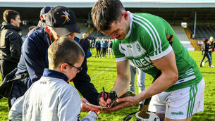 <p>TJ Reid takes time to sign an autograph for supporter Matthew Groarke at the end of the game. Picture: INPHO/Ken Sutton</p>