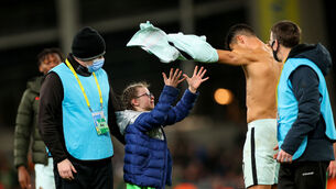 <p>Portugal's Cristiano Ronaldo gives his shirt to a young fan after the game</p>