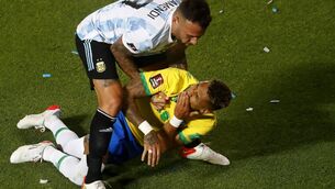 <p>SAN JUAN, ARGENTINA - NOVEMBER 16: Nicolas Otamendi of Argentina holds Raphinha of Brazil after a foul during a match between Argentina and Brazil as part of FIFA World Cup Qatar 2022 Qualifiers at San Juan del Bicentenario Stadium on November 16, 2021 in San Juan, Argentina. (Photo by Marcos Brindicci/Getty Images)</p>