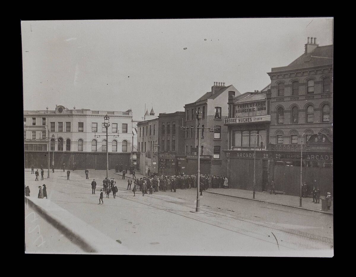 A photograph from 1920, showing Patrick Street just before the Burning of Cork, where a crowd is gathered to observe Terence McSwiney's funeral. Pic: Cork Public Museum