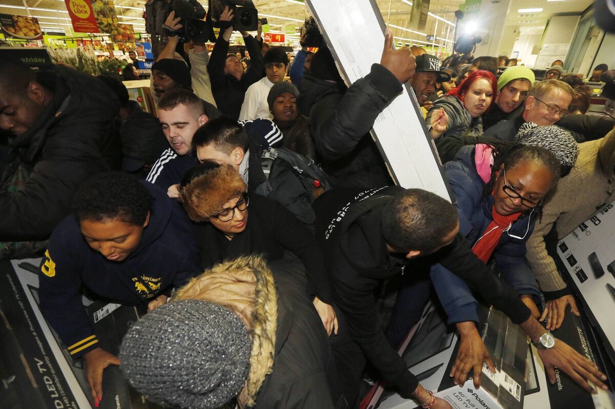 Shoppers compete to purchase retail items on 'Black Friday'. Picture: Luke MacGregor/REUTERS Shoppers compete to purchase retail items on 'Black Friday'. Picture: Luke MacGregor/REUTERS