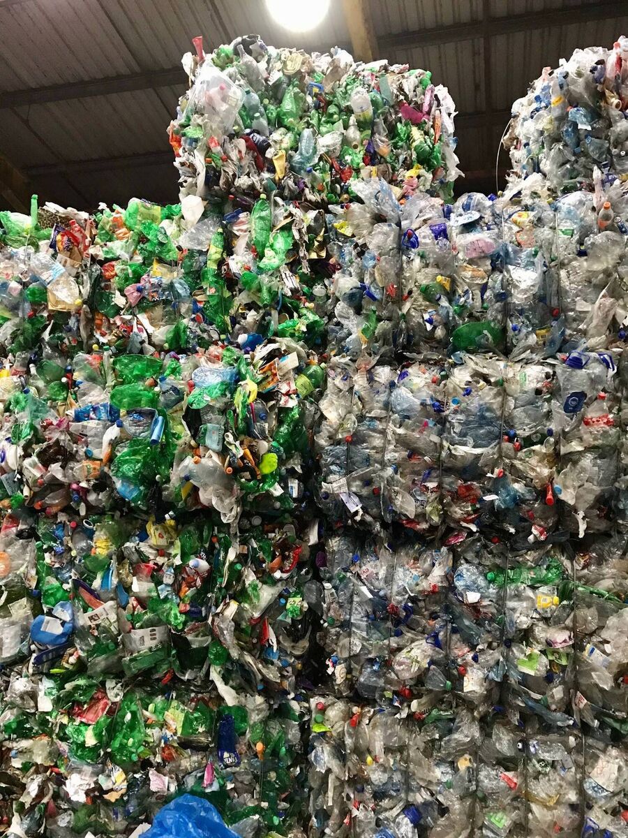 Stacked bales of plastic for recycling.