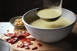Brussels sprout soup with candied bacon and roasted hazelnuts