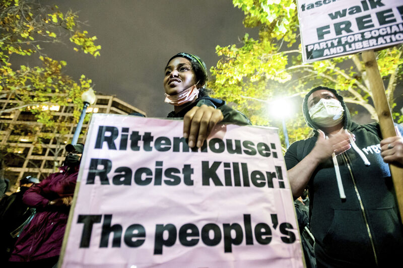 Bria Swenson holds a sign in Oakland, California, following the acquittal of Kyle Rittenhouse. Picture: Noah Berger/AP