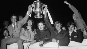 <p>Cork Hibernians’ hat-trick hero Miah Dennehy, left, holding the FAI Cup with captain Dave Bucuzzi, right, amid a group of jubilant supporters following his team’s dramatic 3-0 win over Waterford in the final, played at Dalymount Park on April 23rd 1972.</p>