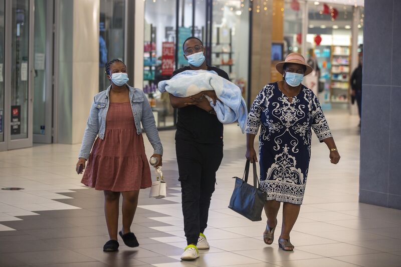 People with masks walk at a shopping mall in Johannesburg, South Africa.