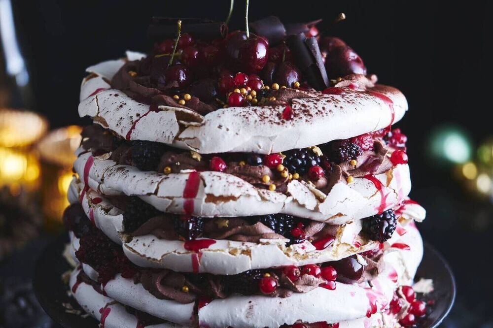 Showstopping meringue layer cake with chocolate cream and fresh berries